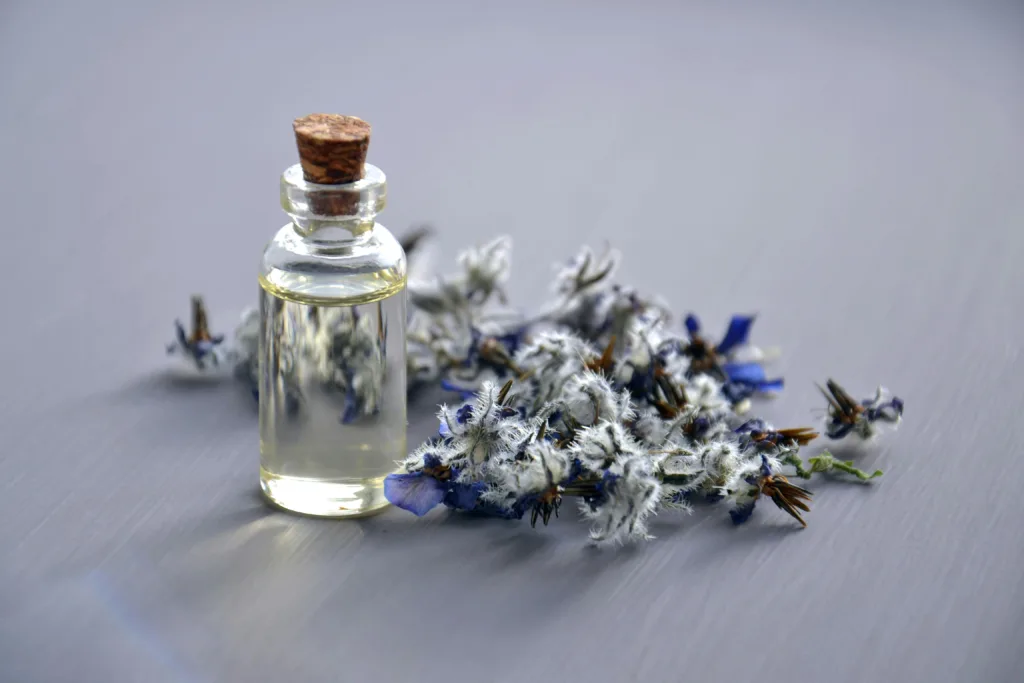 Close-up of a lavender oil bottle with dried flowers for aromatherapy. Perfect for wellness themes.