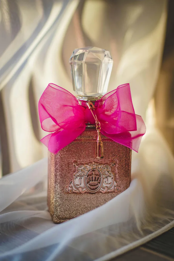 Luxurious perfume bottle adorned with a pink ribbon, capturing elegance and romance.